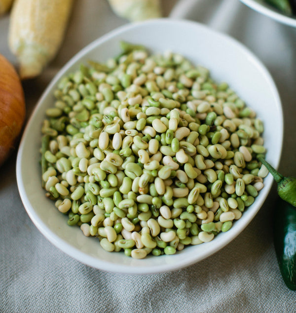 A white bowl overflowing with lady peas