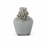 Medium light blue ceramic vase with a raised flower