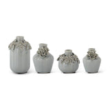 Four light blue raised floral ceramic vase shapes