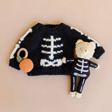 Skeleton Bear styled with a skeleton sweater and pumpkin rattle, Stone Hollow Farmstead