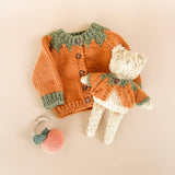 Pumpkin Cardigan styled with a bear and pumpkin rattle, Stone Hollow Farmstead