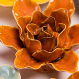 Burnt Orange Stargazer Lily Ceramic Wall Flower styled with coordinating ceramic flowers at Stone Hollow Farmstead