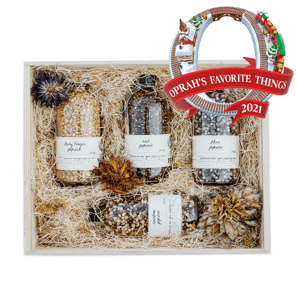 Heirloom Popcorn Gift Box with four rotating popcorn selections in a wooden gift box adorned with dried flowers
