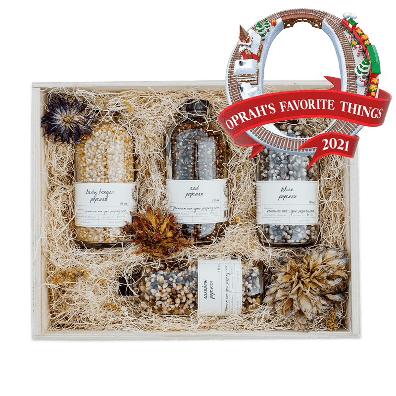 Heirloom Popcorn Gift Box with four rotating popcorn selections in a wooden gift box adorned with dried flowers